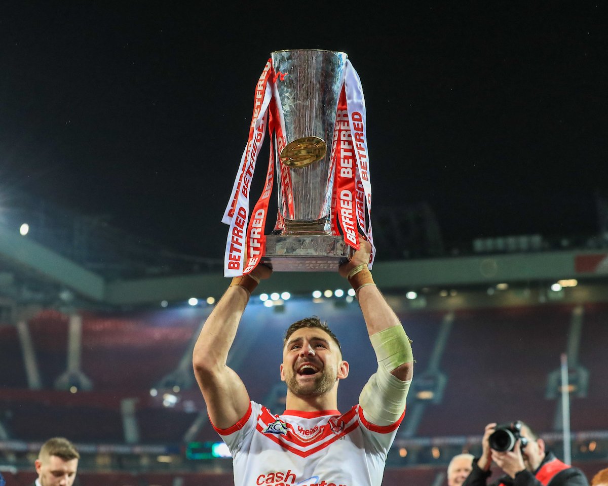 Tommy Makinson lifts the Super League trophy aloft at Old Trafford, playing for St Helens.