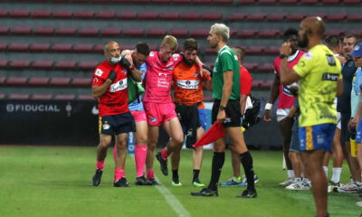 Max Simpson of Leeds Rhinos is helped off the field after suffering an injury.