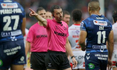 James Child, wearing pink referee's kit, makes a decision.