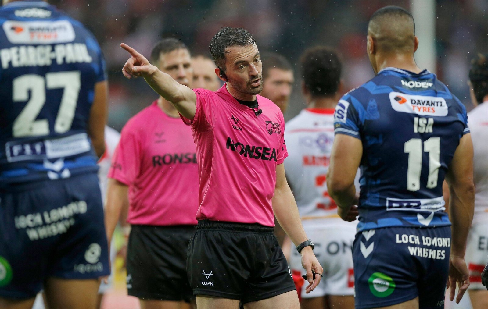James Child, wearing pink referee's kit, makes a decision.
