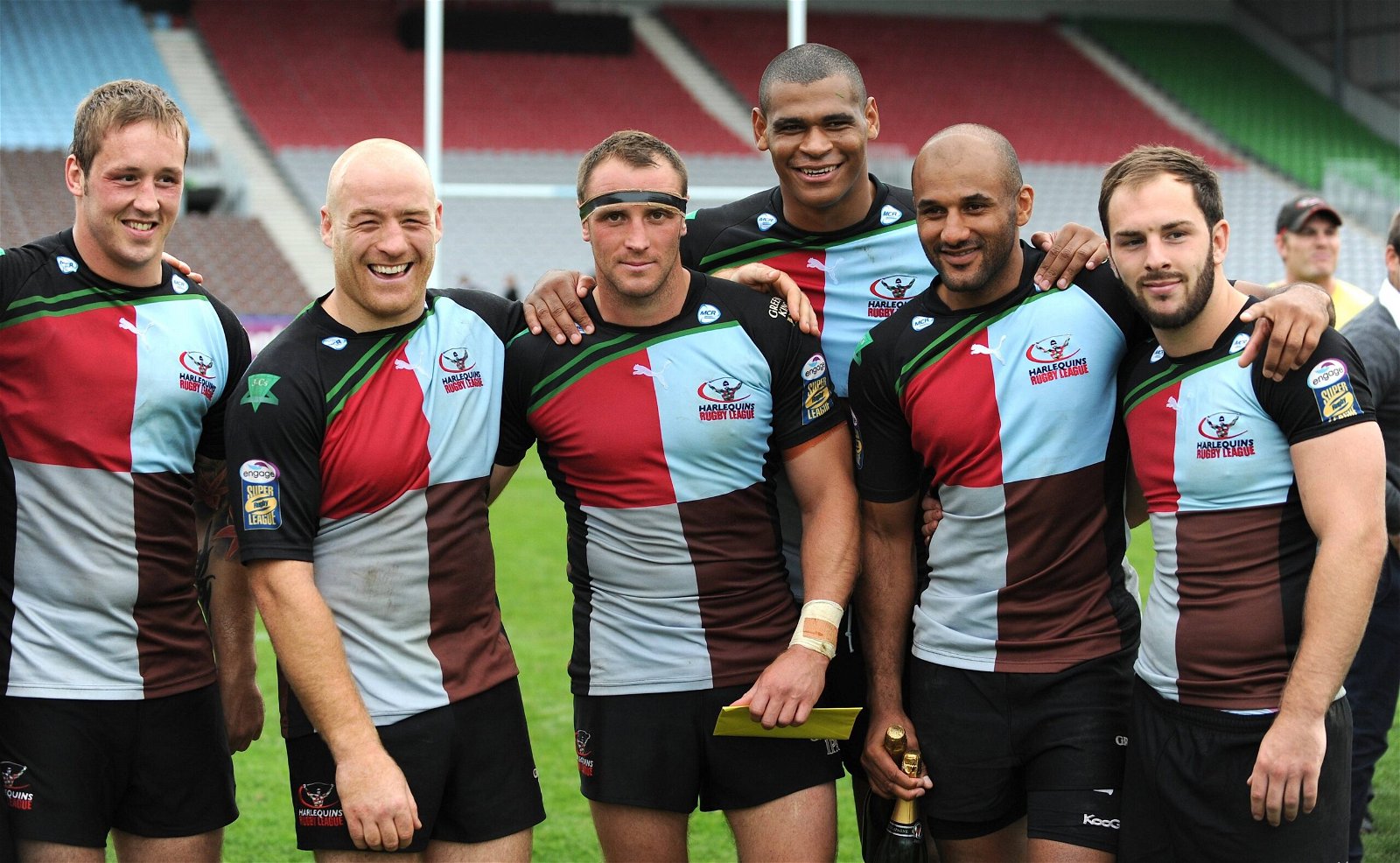 Harlequins RL players stand posing for the camera at an empty Twickenham Stoop, where London Broncos will face St Helens.