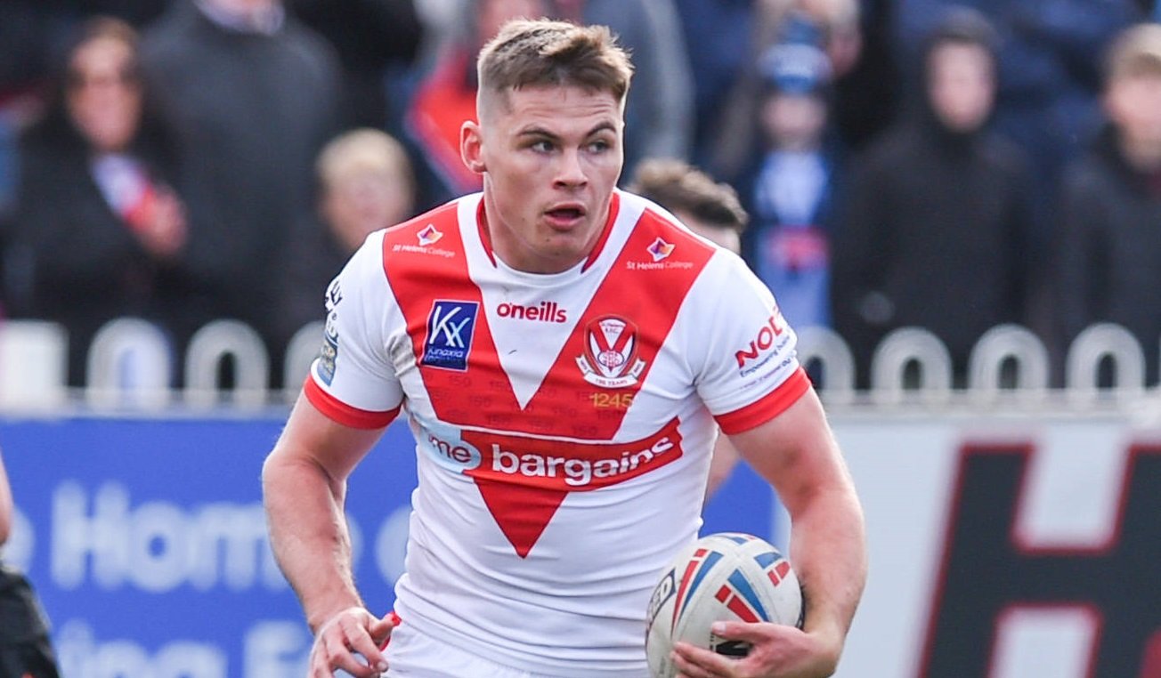 Jack Welsby in Super League action for St Helens. He holds the ball in his left hand.