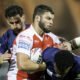 Hull KR's Matty Storton is tackled by Wigan's Toby King