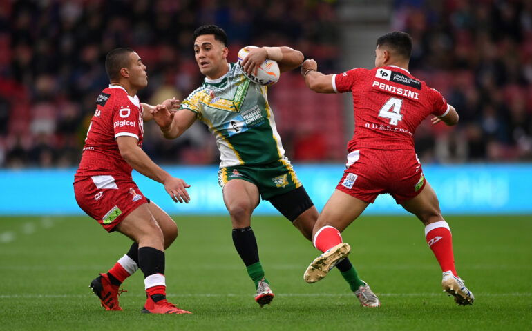 Cook Islands' Kayal Iro (centre) tackled by Tonga's Will Penisini