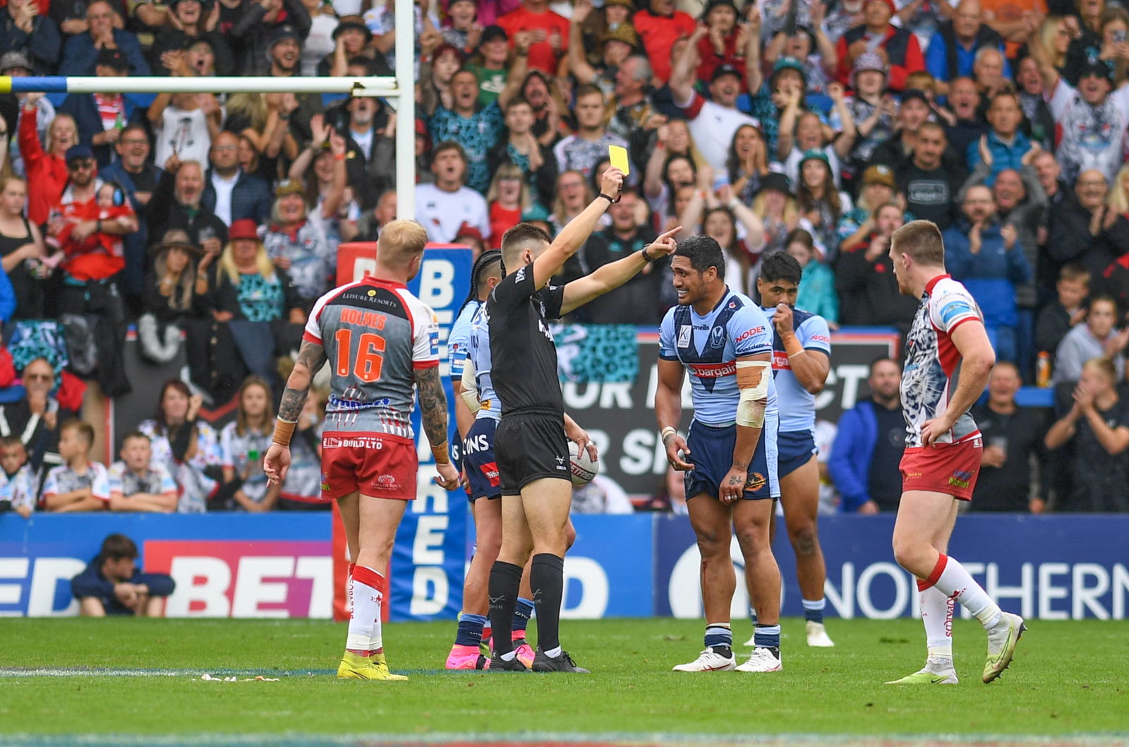 Referee Chris Kendall showing the yellow card to St Helens' Sione Mata'utia