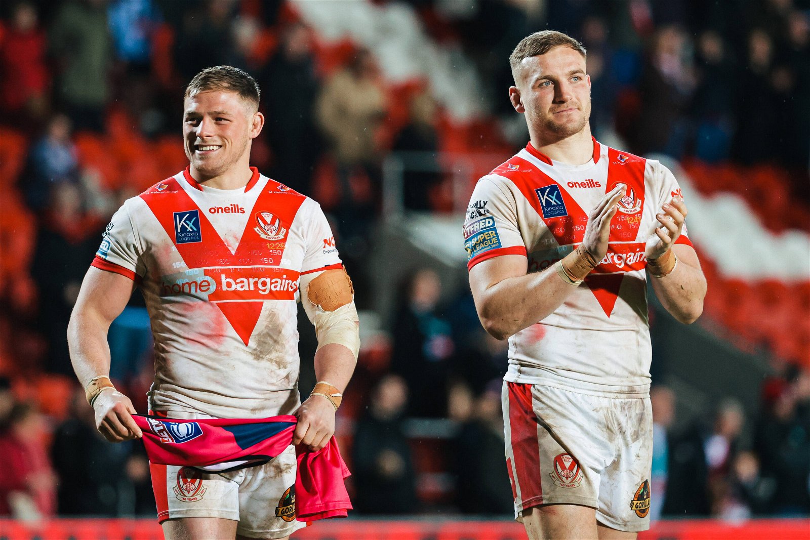 Matty Lees and Morgan Knowles clap in St Helens shirts.