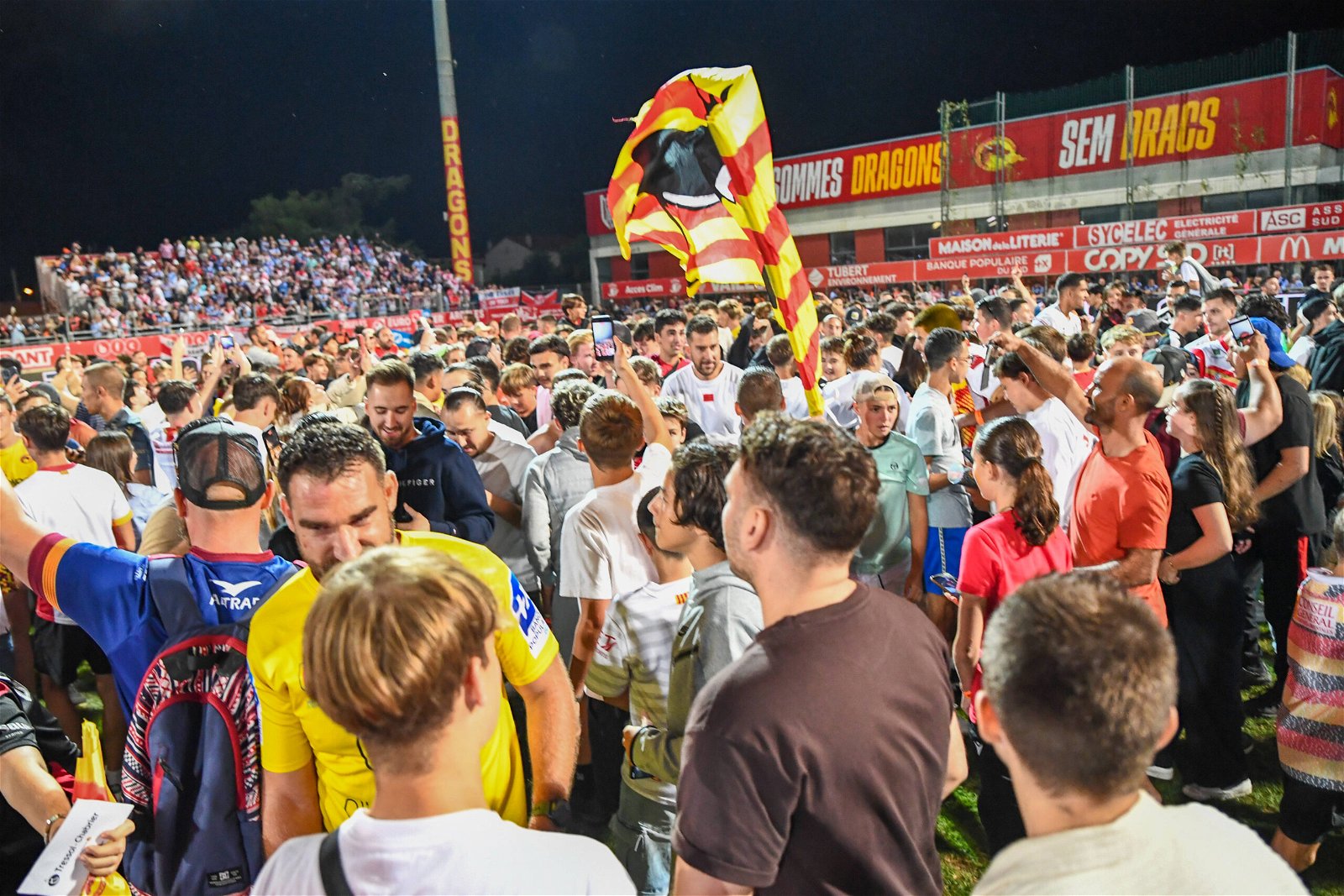 Catalans Dragons celebrate on the pitch at the Stade Gilbert Brutus