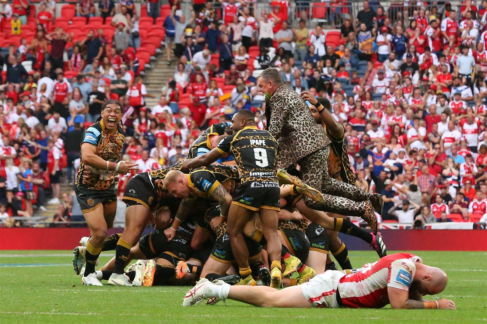 Leigh Leopards celebrate winning the Challenge Cup, as players pile-on. At Wembley Stadium.