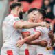 Lewis Dodd celebrates with Alex Walmsley and James Bell after scoring a try for St Helens
