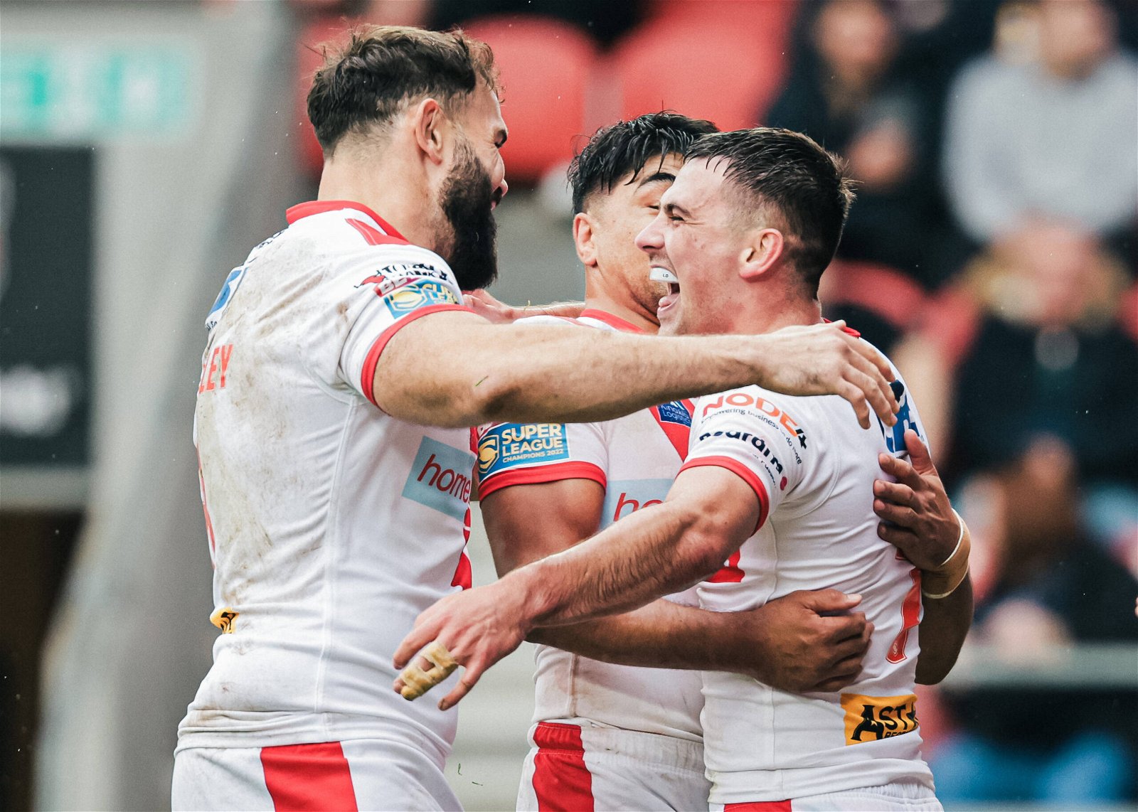Lewis Dodd celebrates with Alex Walmsley and James Bell after scoring a try for St Helens