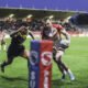 Castleford Tigers Charbel Tasipale attempts to stop Catalans Dragons winger Tom Johnstone from scoring a try.