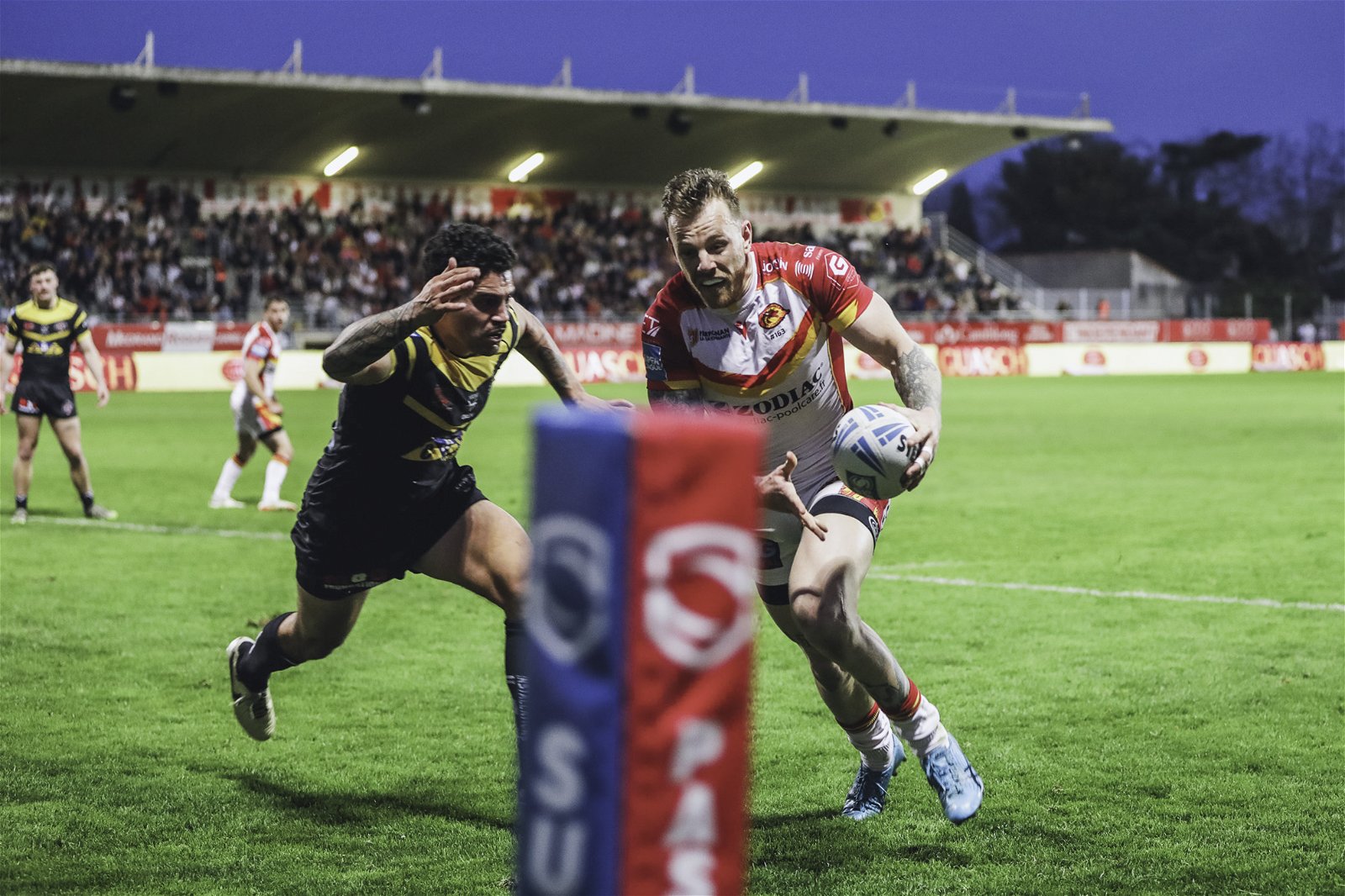Castleford Tigers Charbel Tasipale attempts to stop Catalans Dragons winger Tom Johnstone from scoring a try.