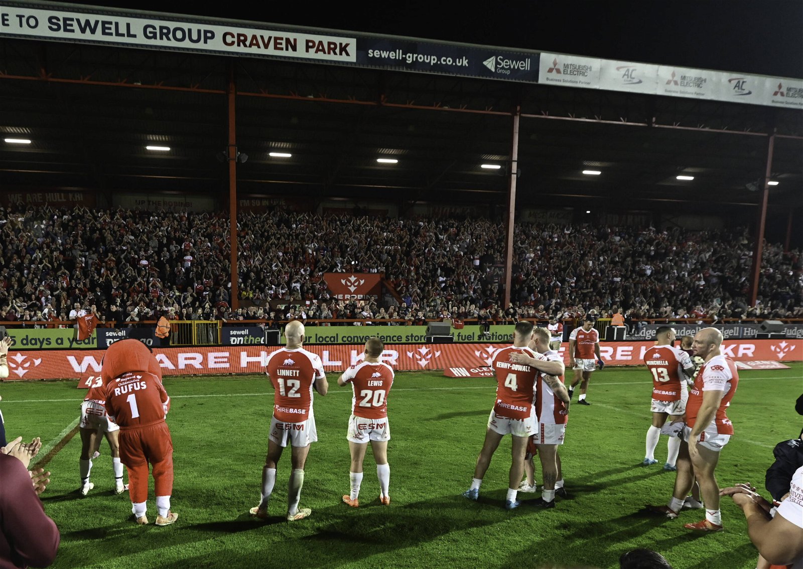 Hull KR players clap in front of a full stand at Craven Park