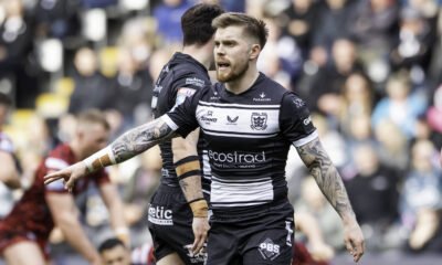 Morgan Smith, wearing Hull FC's new shirt. It's predominantly black, with a white stripe across where the badge is, and one right near the bottom as well. Where there should usually be a middle stripe, the Ecostrad logo is. White sleeve cuffs finish it off, as well as the Summit Vans and Castore logos in black on the top white stripe, and above that, the Paragon logo in white.