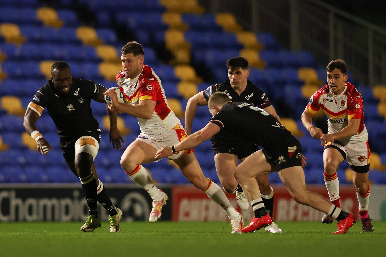 Bayley Sironen of Catalan Dragons breaks through the Broncos defence during the Super League match between London Broncos and Catalan Dragons at Plough Lane.