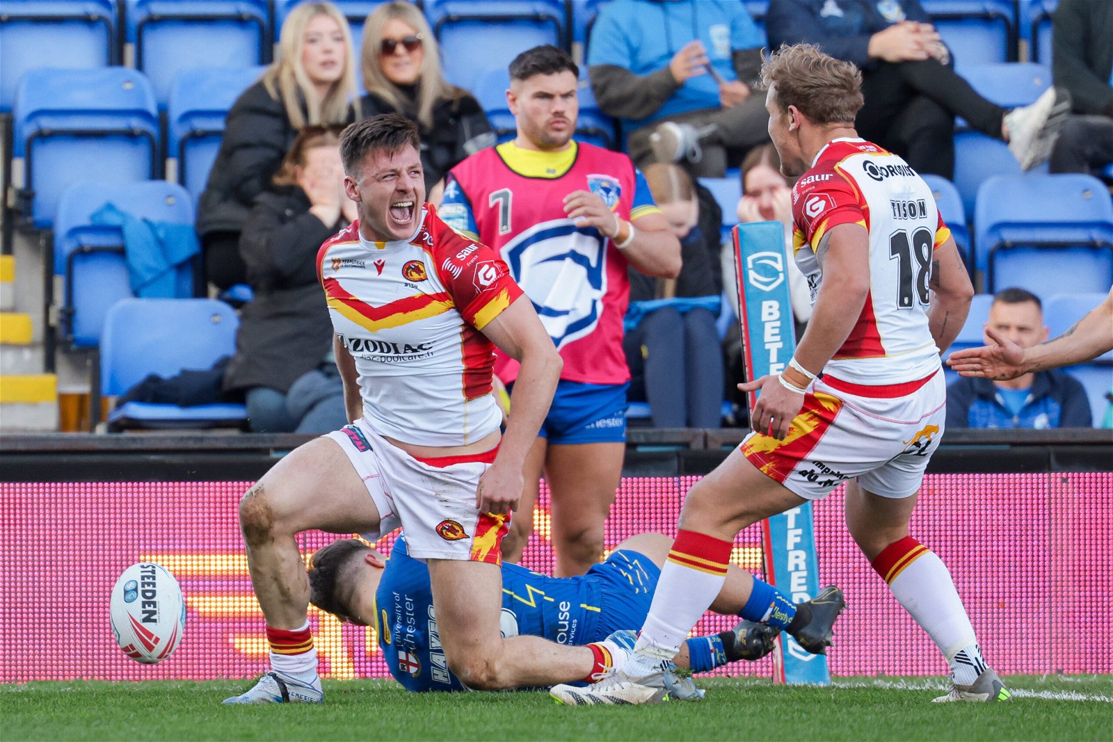 Catalans Dragons winger Tom Davies with Ugo Tison celebrates scoring in the corner against Warrington Wolves in the Super League.