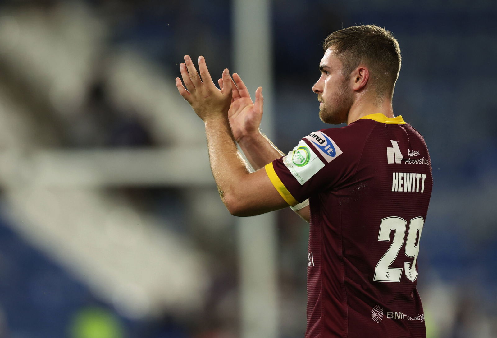 Sam Hewitt claps in a Huddersfield Giants shirt.