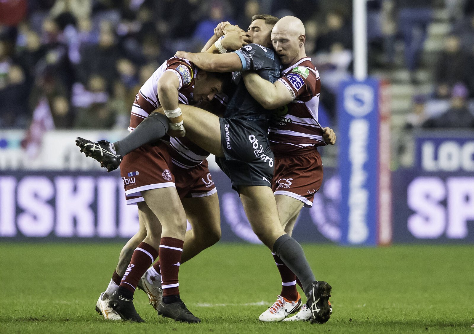 Sam Hewitt Huddersfield Giants tackled by Wigan Warriors players