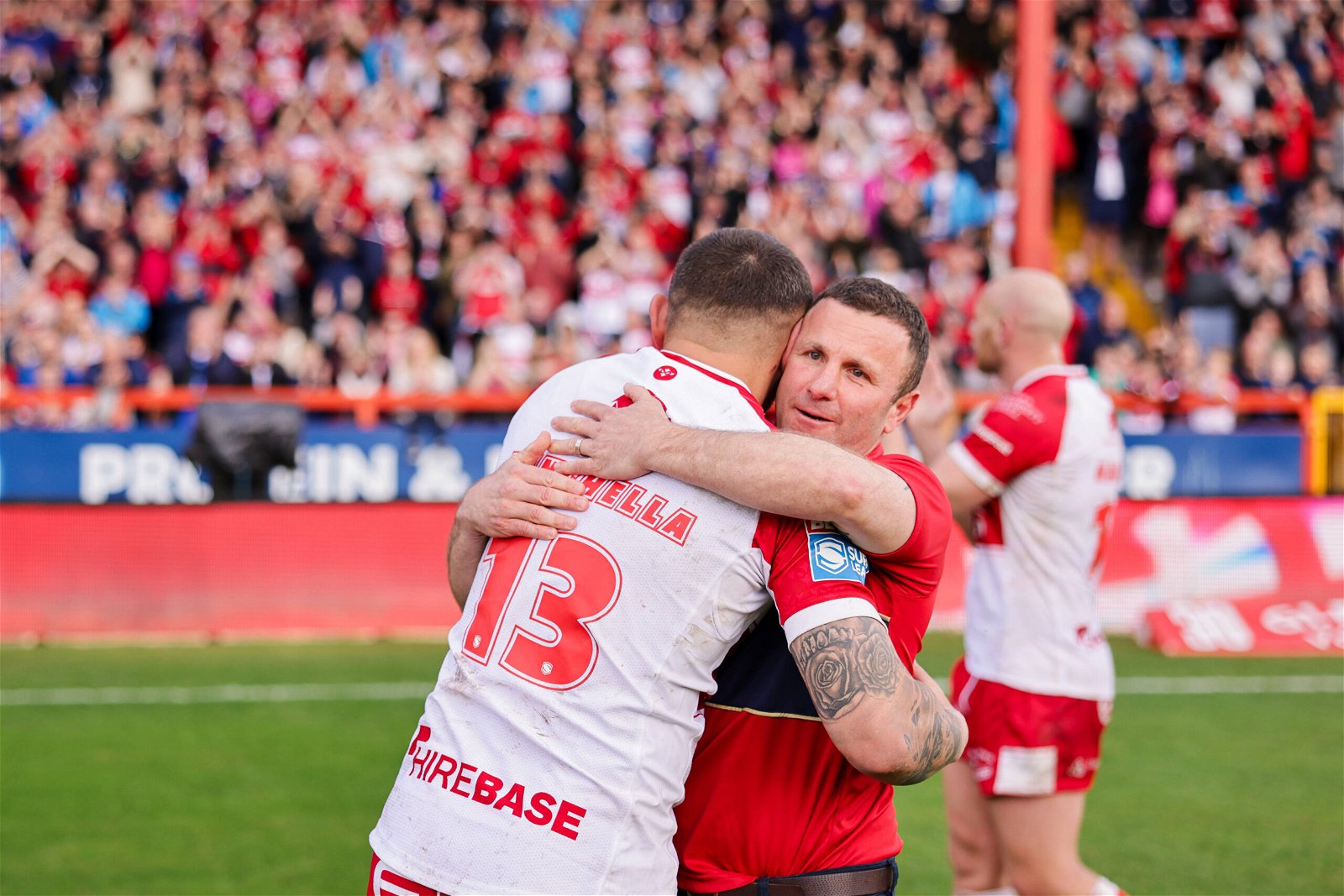 Elliot Minchella and head coach Willie Peters of Hull KR celebrate the win over St Helens.