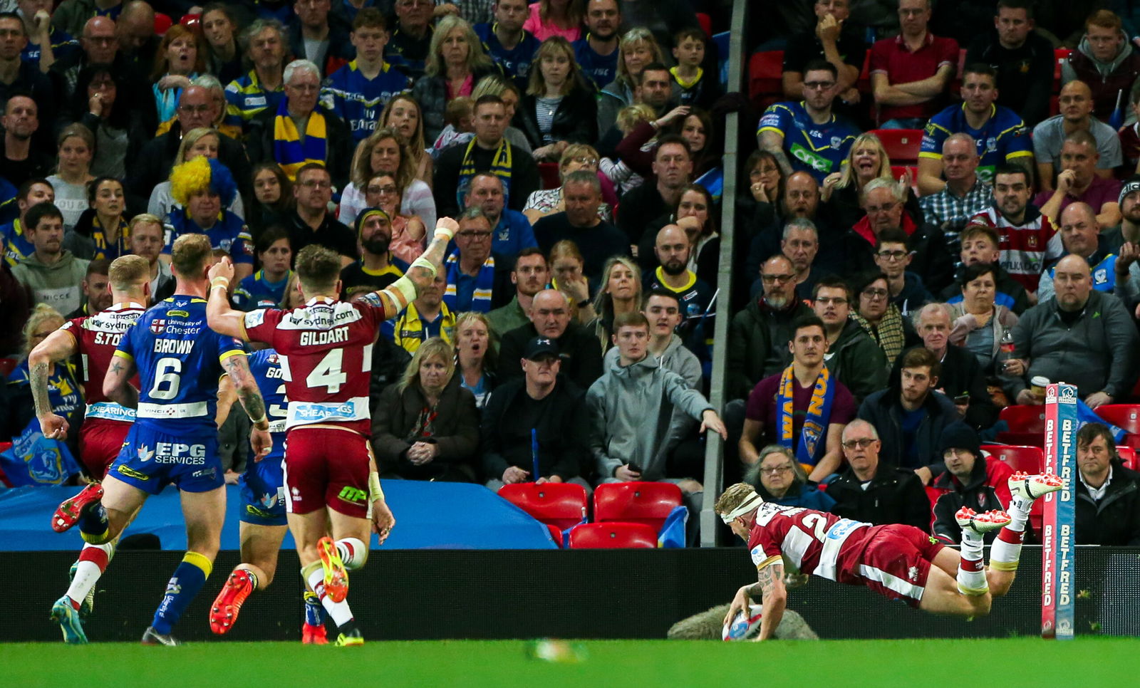 Wigan's Dom Manfredi scores a try against Warrington Wolves.