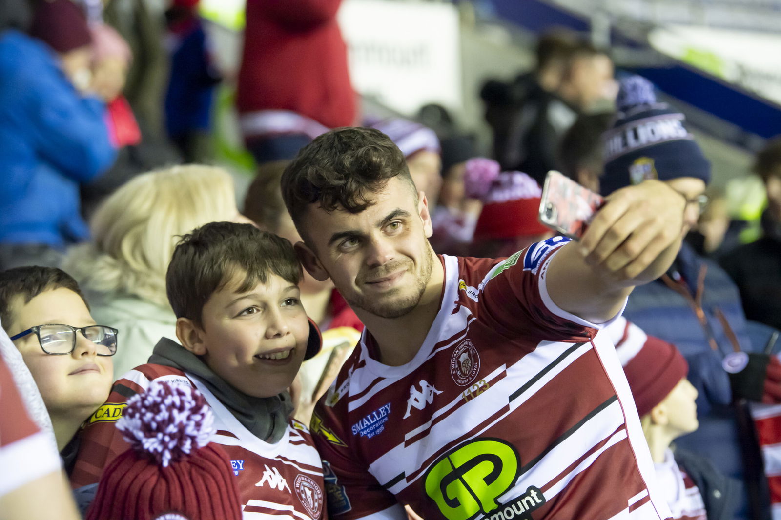Wigan Warriors Tom Forber with fans and supporters.
