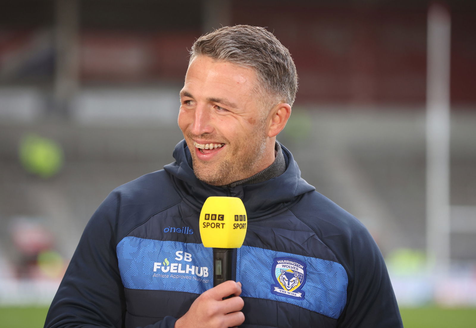 Sam Burgess with a BBC Sport microphone during the Challenge Cup coverage.  Warrington Wolves Super League