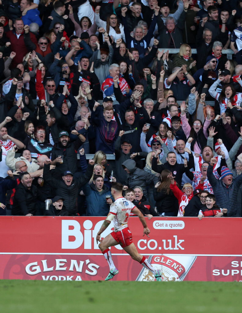 Tommy Makinson of St Helens celebrates a Super League try against Wigan Warriors.