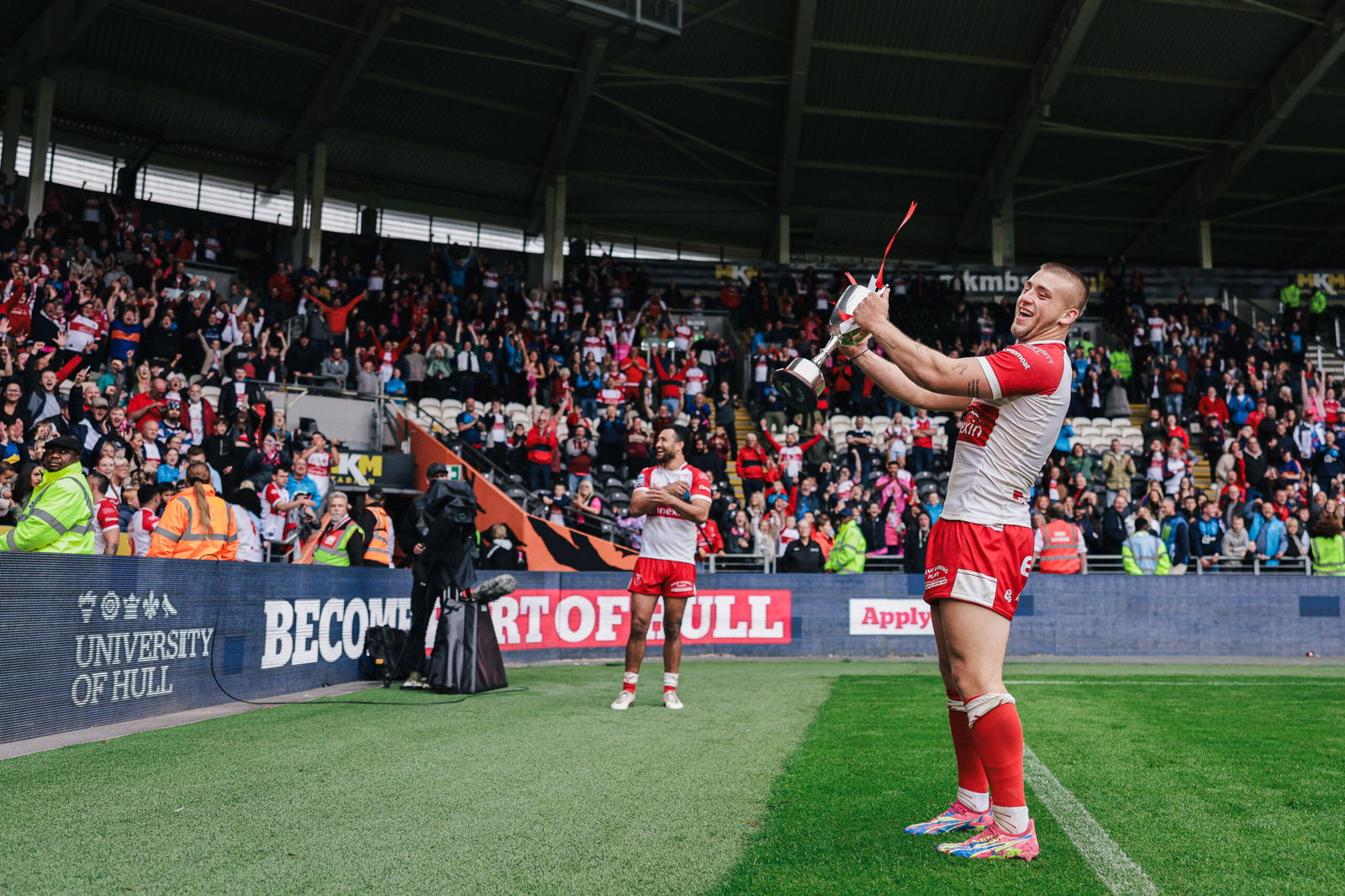 Super League presence Mikey Lewis celebrates with a trophy after Hull KR beat Hull FC