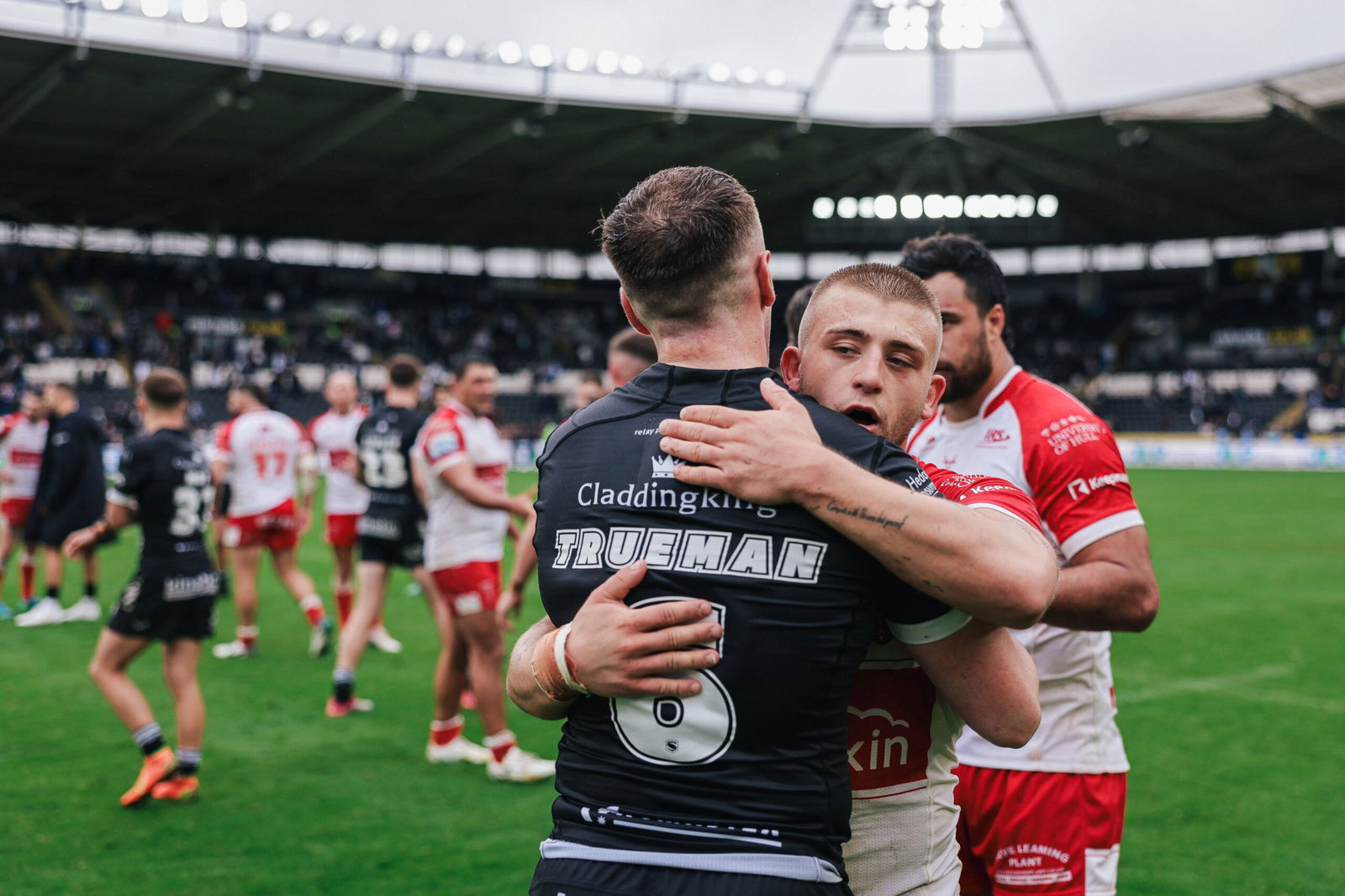 Hull KR's Mikey Lewis hugs Hull FC's Jake Trueman