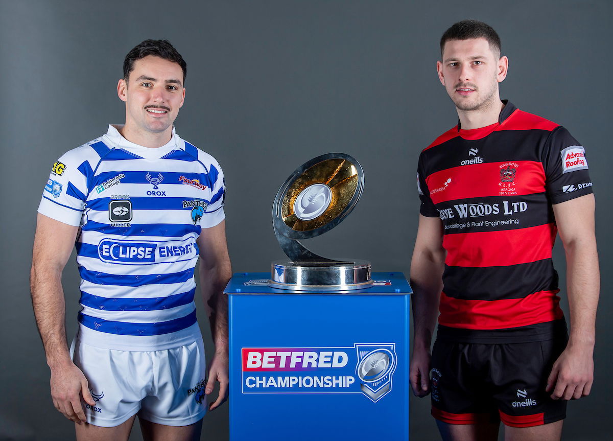 Halifax player Louis Jouffret and Barrow player Brad Walker with Championship trophy