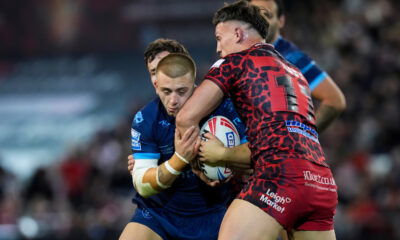 Hull KR's Mikey Lewis being tackled by Leigh Leopards players