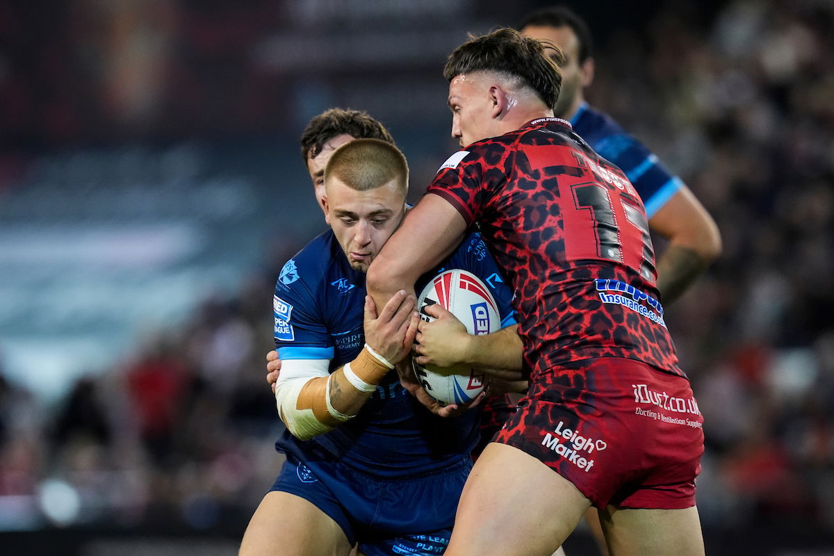 Hull KR's Mikey Lewis being tackled by Leigh Leopards players