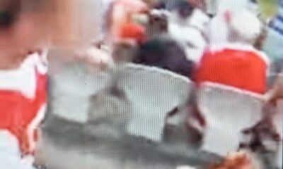 Rugby League fan allegedly throwing a pie at a rival supporter.