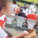 Rugby League fan allegedly throwing a pie at a rival supporter.