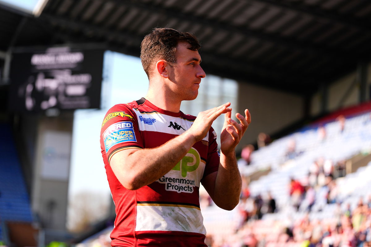 Wigan Warriors halfback Harry Smith applauds the fans