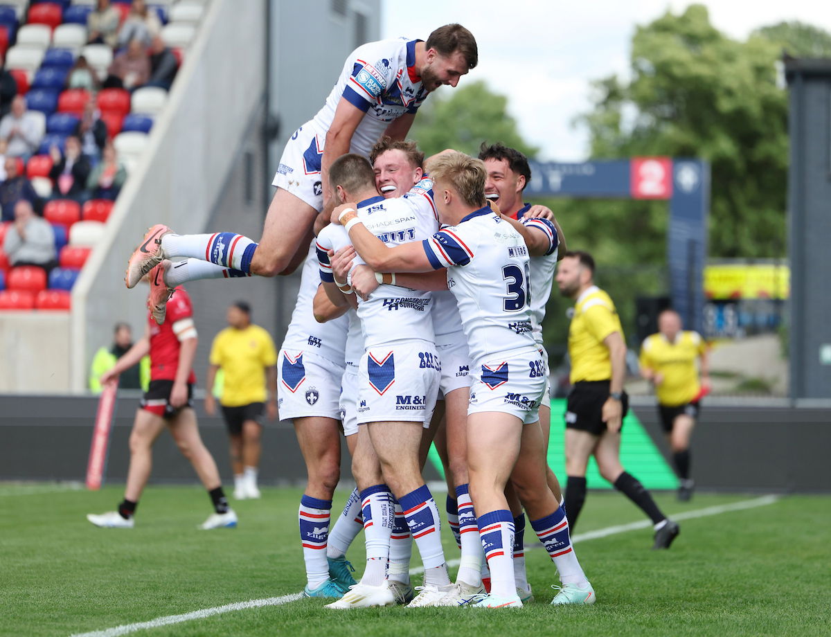 Wakefield Trinity celebrate Ellis Lingard's try against Salford Red Devils