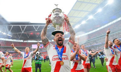 Hull KR captain Elliot Minchella lifting the Challenge Cup trophy