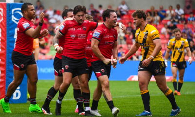 Rugby league fans react to Salford Red Devils victory as players celebrate a try